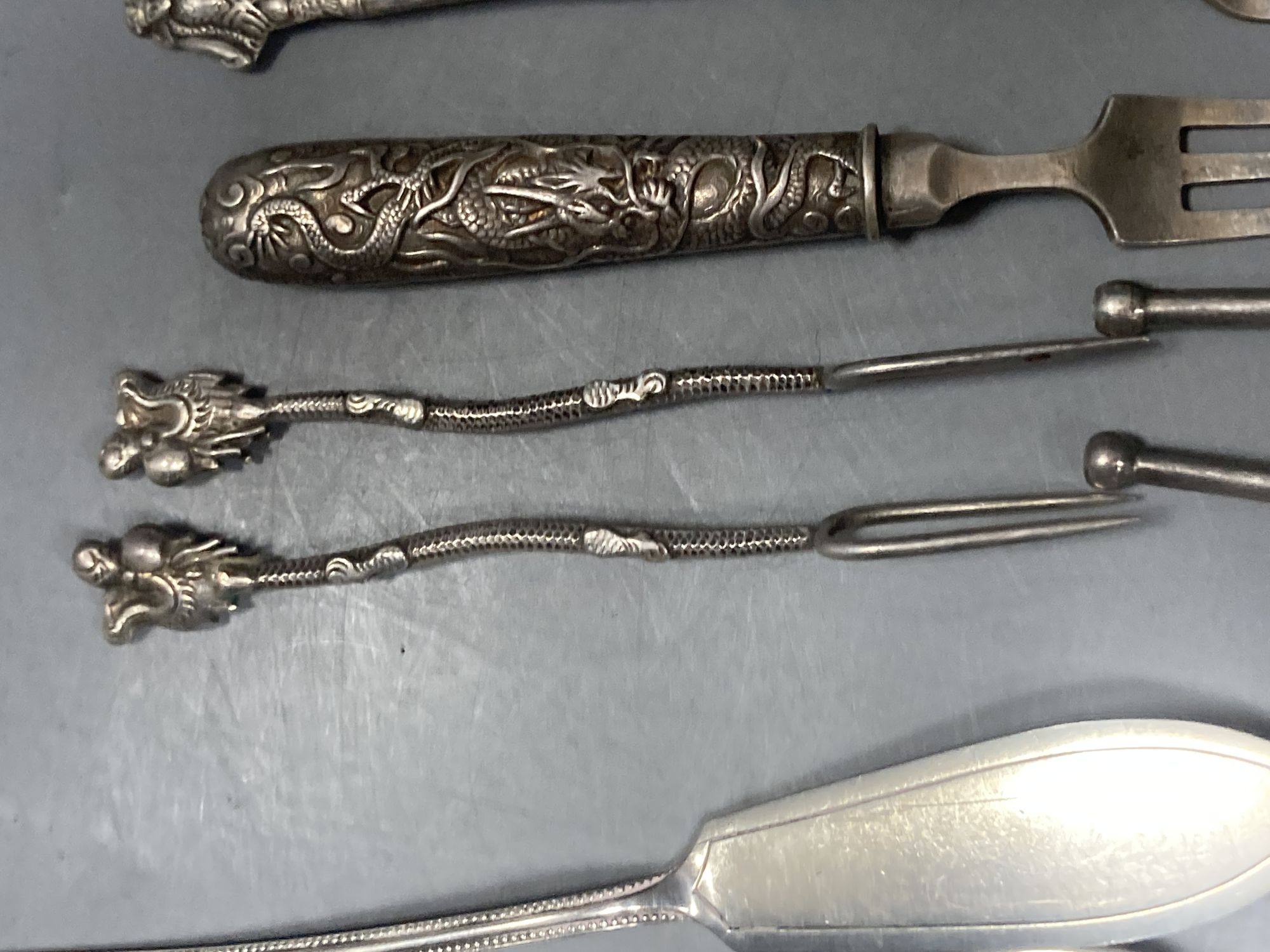 A group of assorted Chinese white metal spoons and forks, including set of six teaspoons and ten small items of English silver.